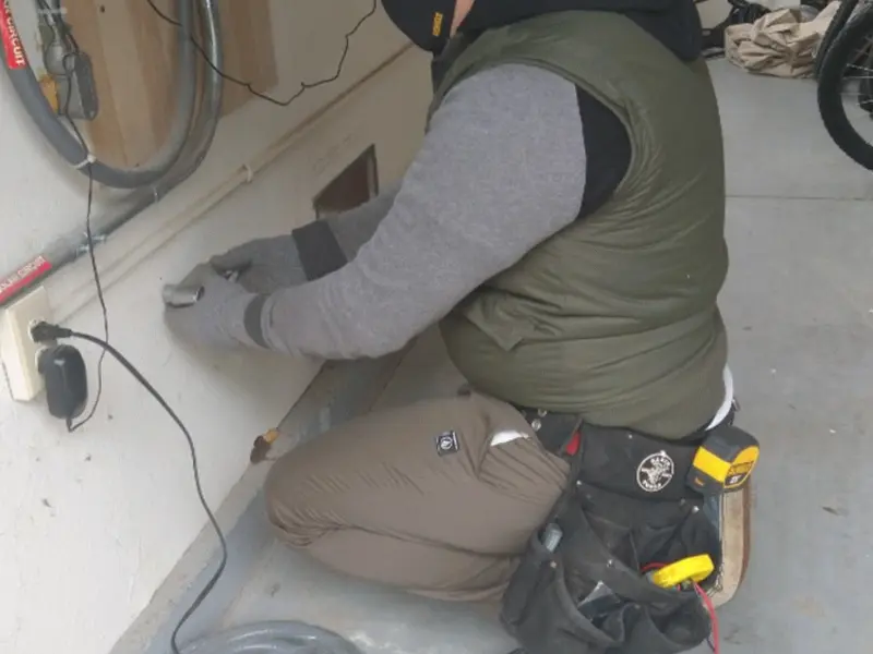 Electrician performing outlet wiring in a Middletown garage